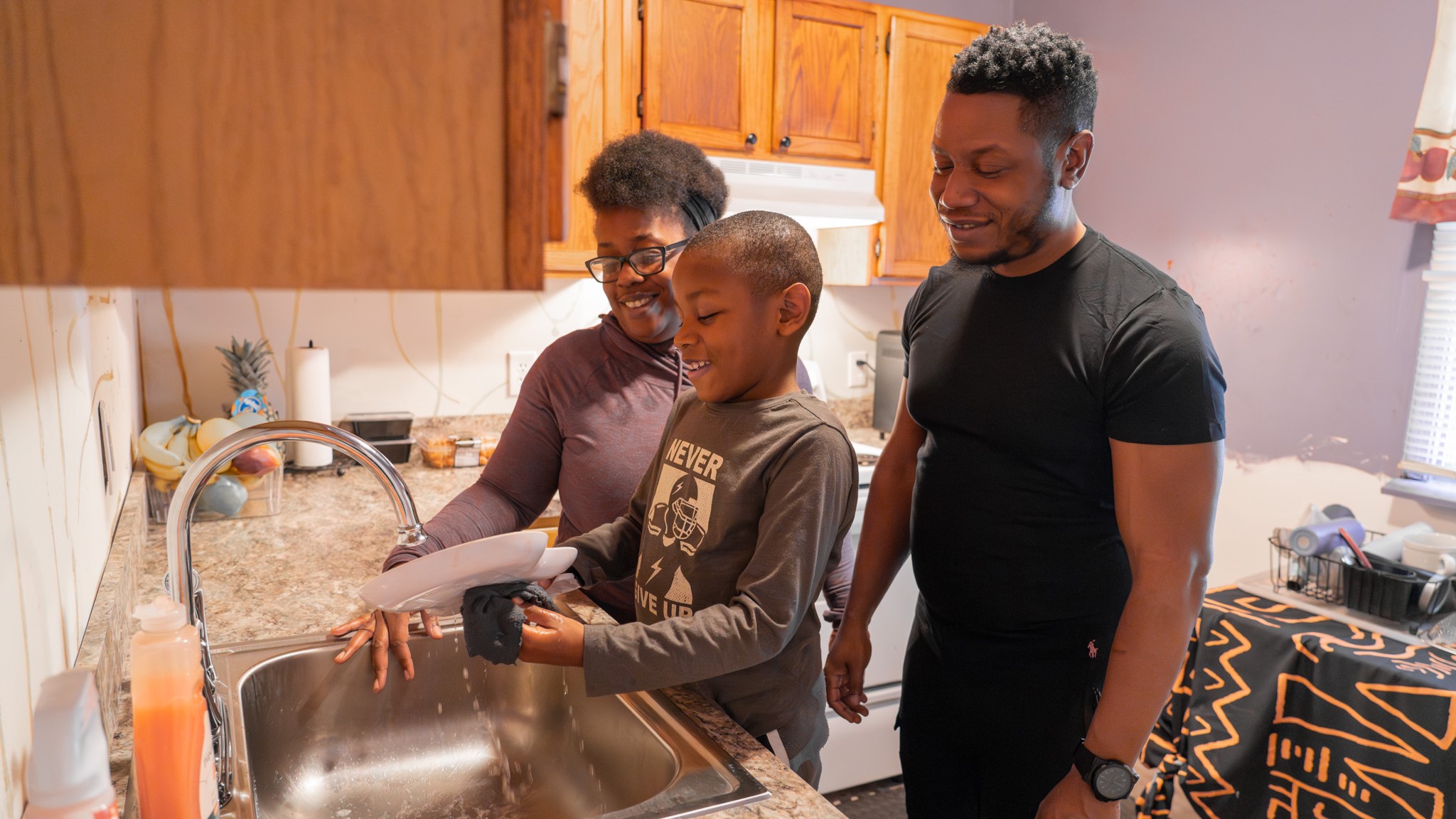Family at kitchen sink
